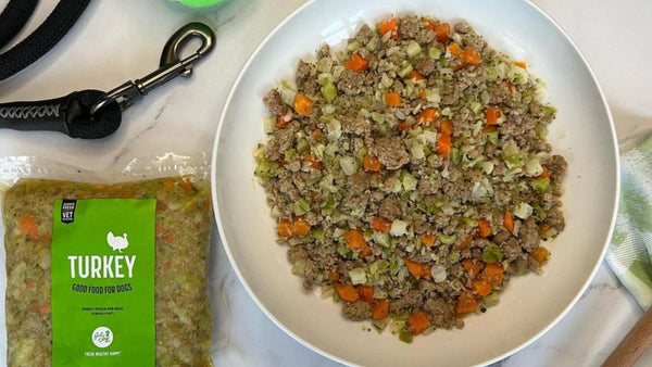 Get Joy Dog Food in a bowl ready to be served along with the packaging for the food next to it. 