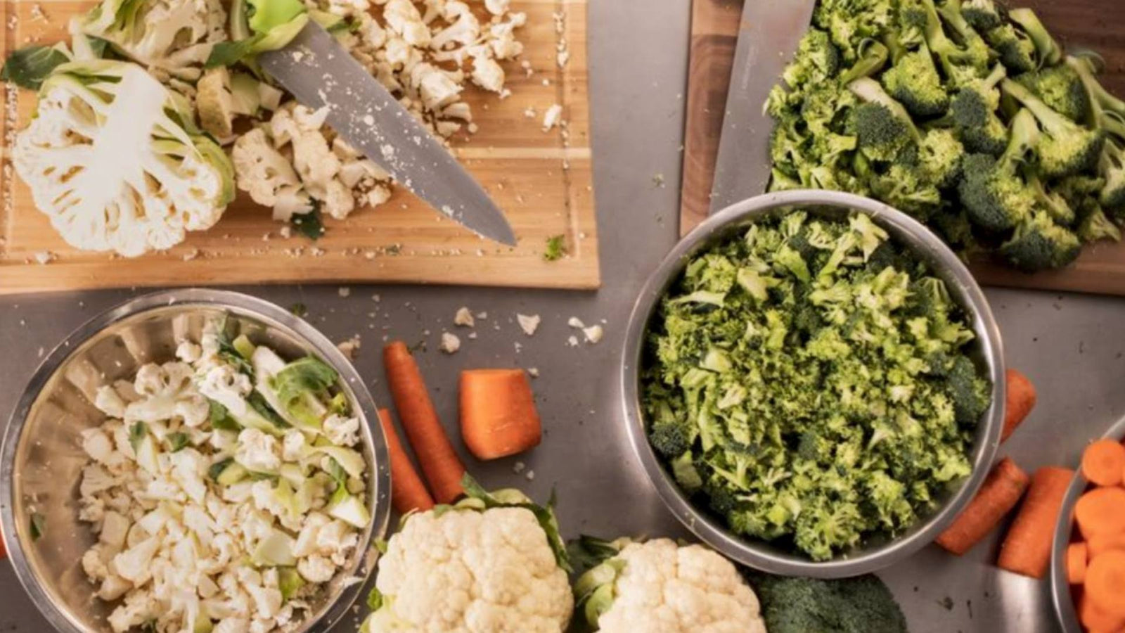 Fresh vegetable ingredients are displayed on a table, demonstrating homemade dog treat recipes for spring.