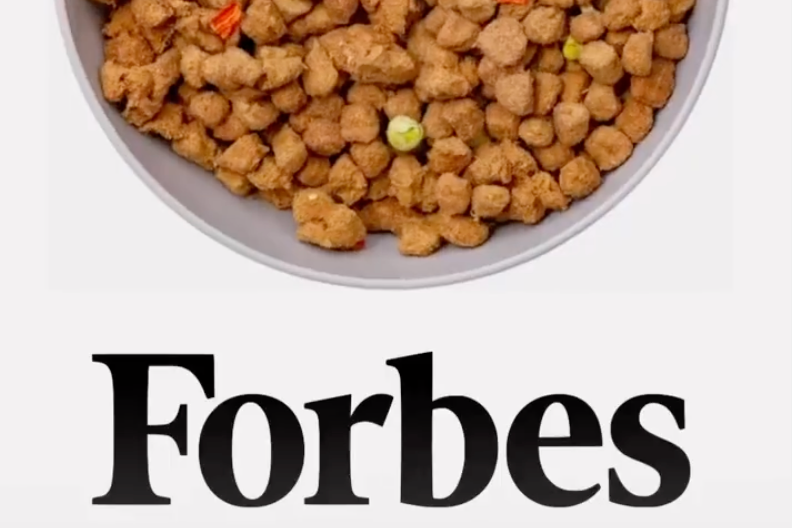 A graphic showing a bowl of Get Joy dog food with the Forbes logo underneath. The Forbes article highlighted Get Joy as a forerunner in Pet Health and Wellness.