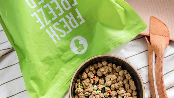 A bag of Get Joy Dog Food's Fresh Fresh Dried Food along with some of it poured into a dog bowl. 