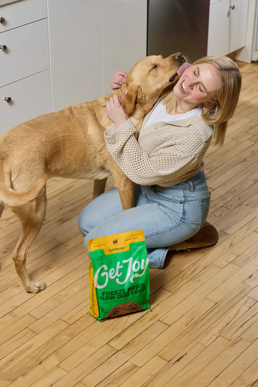 A woman hugging her dog at home